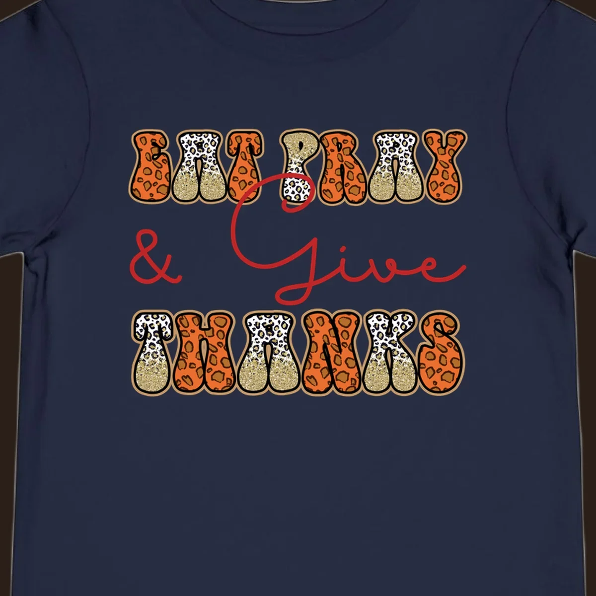Eat Pray Give Thanks leopard print text design with gold glitter accents.