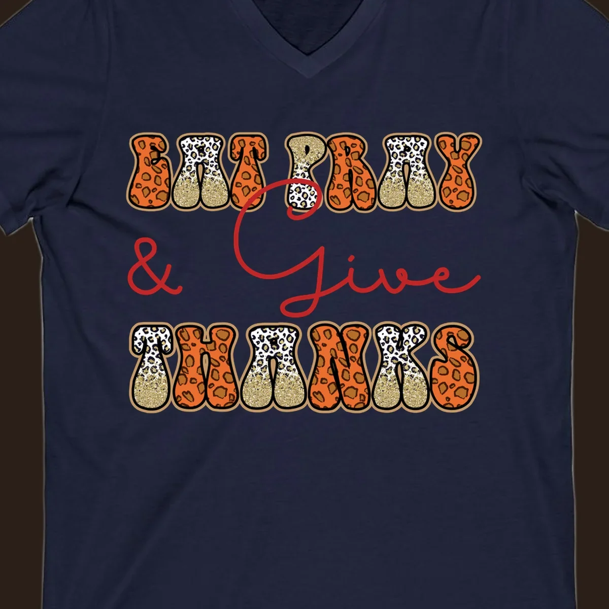 Eat Pray Give Thanks leopard print text design with gold glitter accents.
