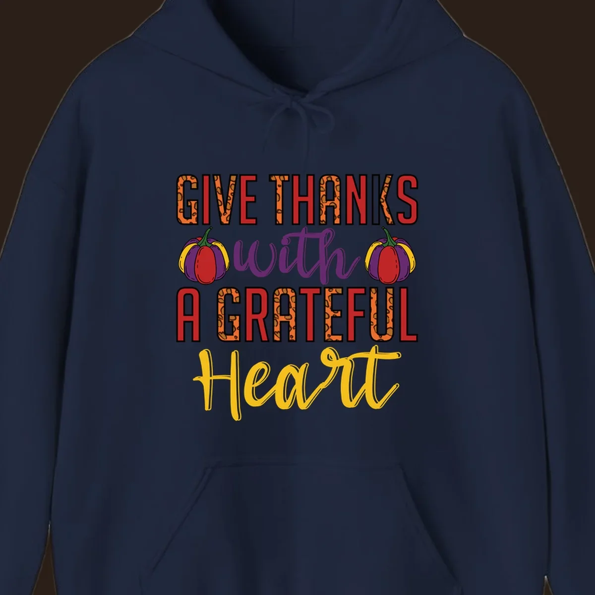 Give Thanks With A Heart typography and pumpkin design.