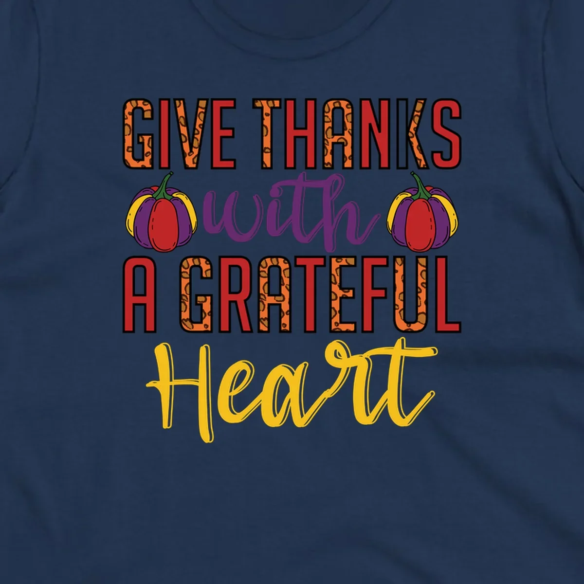 Give Thanks With A Heart typography and pumpkin design.