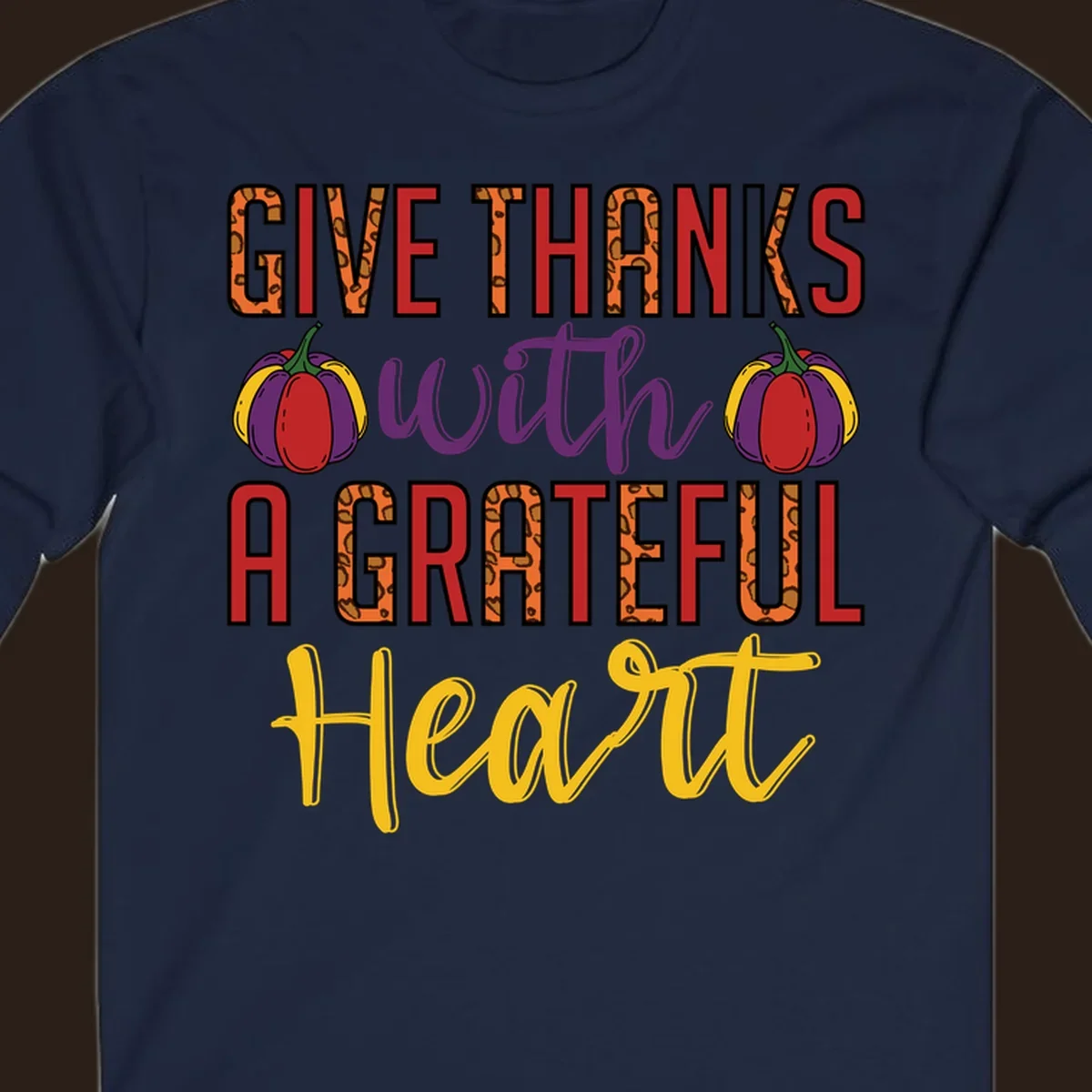 Give Thanks With A Heart typography and pumpkin design.