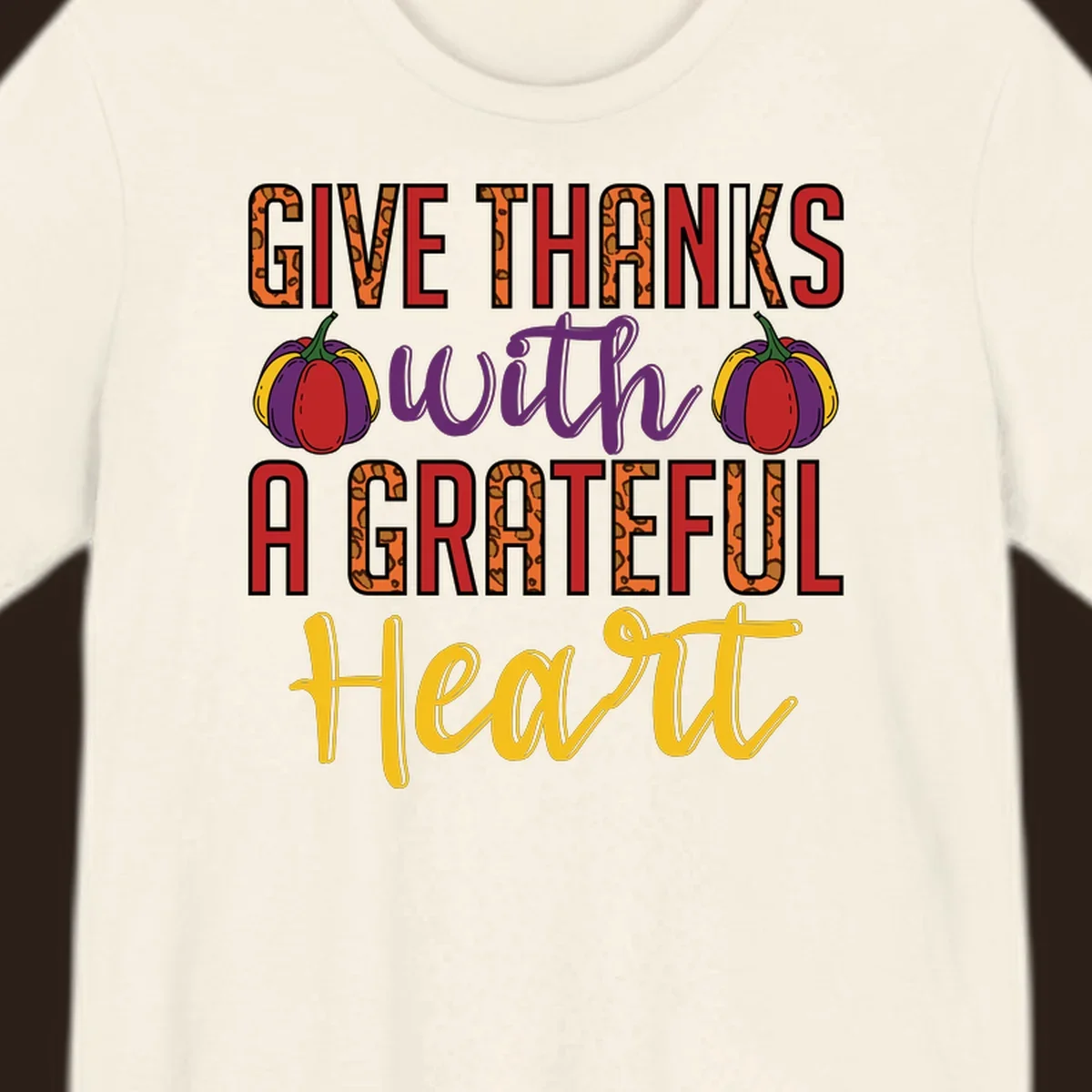 Give Thanks With A Heart typography and pumpkin design.