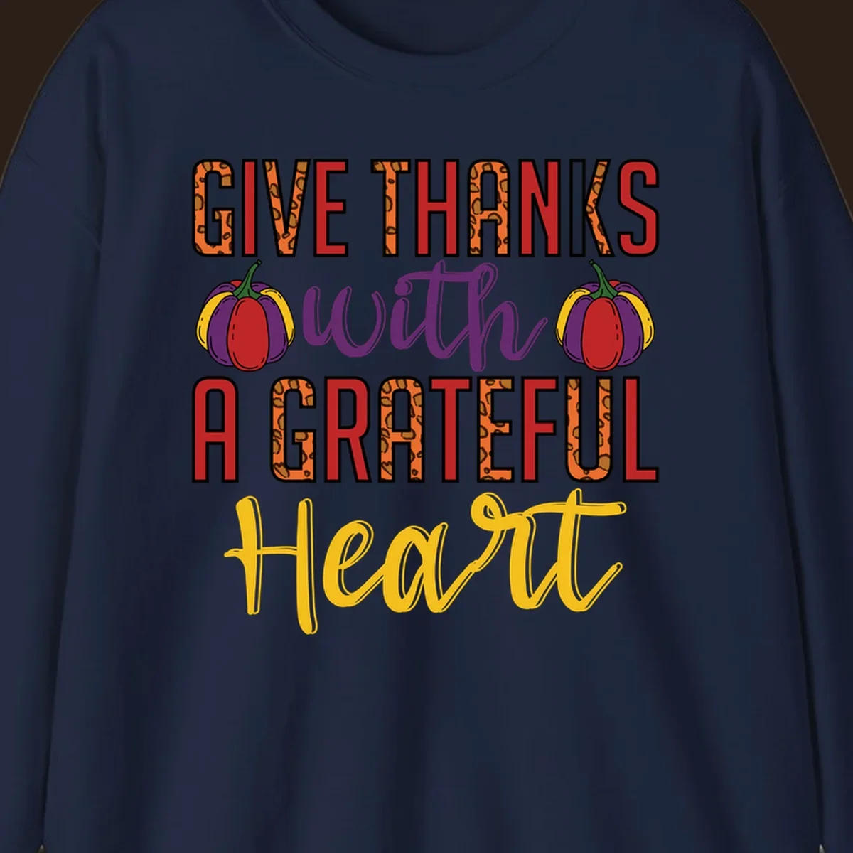 Give Thanks With A Heart typography and pumpkin design.