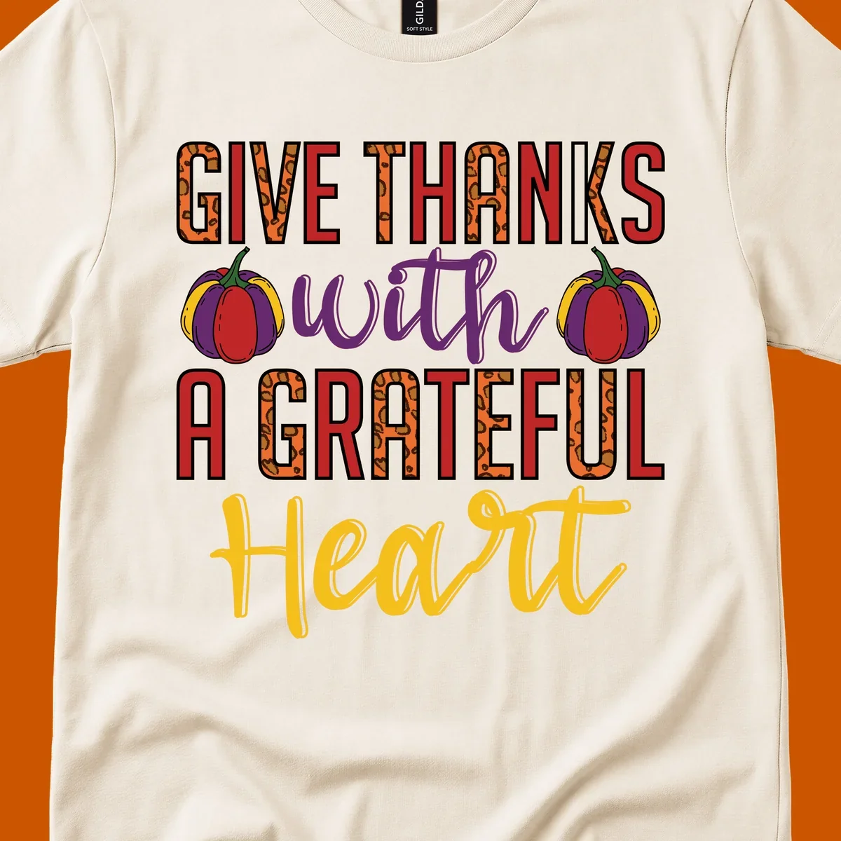 Give Thanks With A Heart typography and pumpkin design.