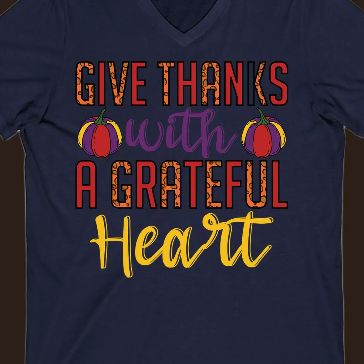 Give Thanks With A Heart typography and pumpkin design.