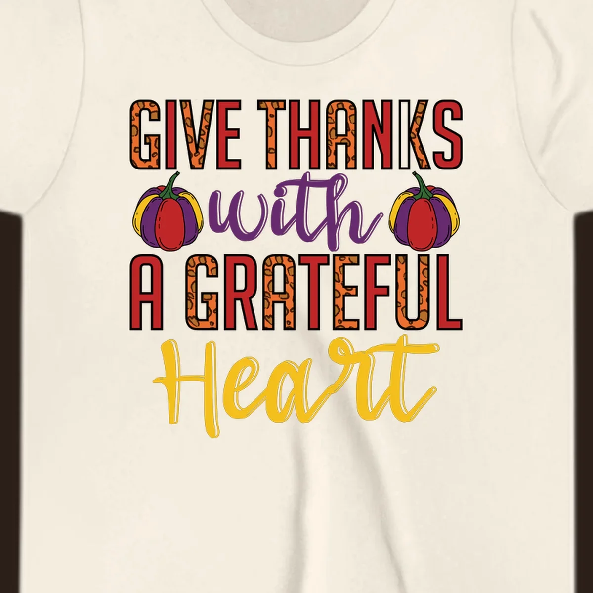 Give Thanks With A Heart typography and pumpkin design.