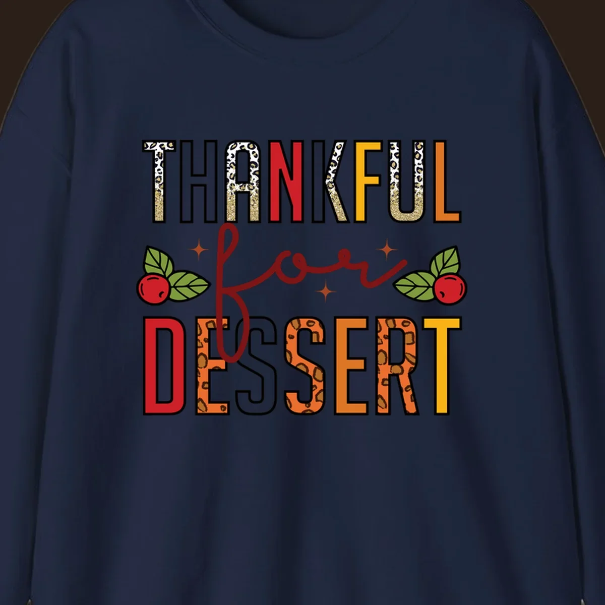 Thankful for Dessert typography with leopard print and cranberries on a dark background.