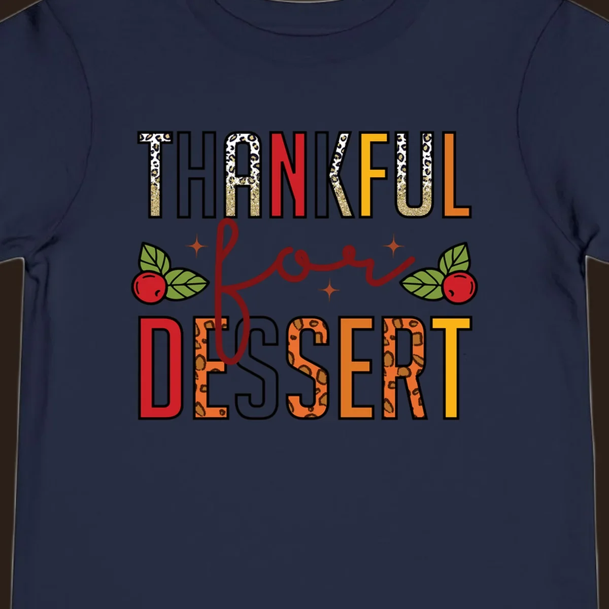 Thankful for Dessert typography with leopard print and cranberries on a dark background.