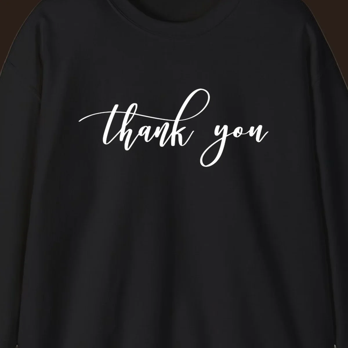 Elegant handwritten thank you script in white on a dark background.