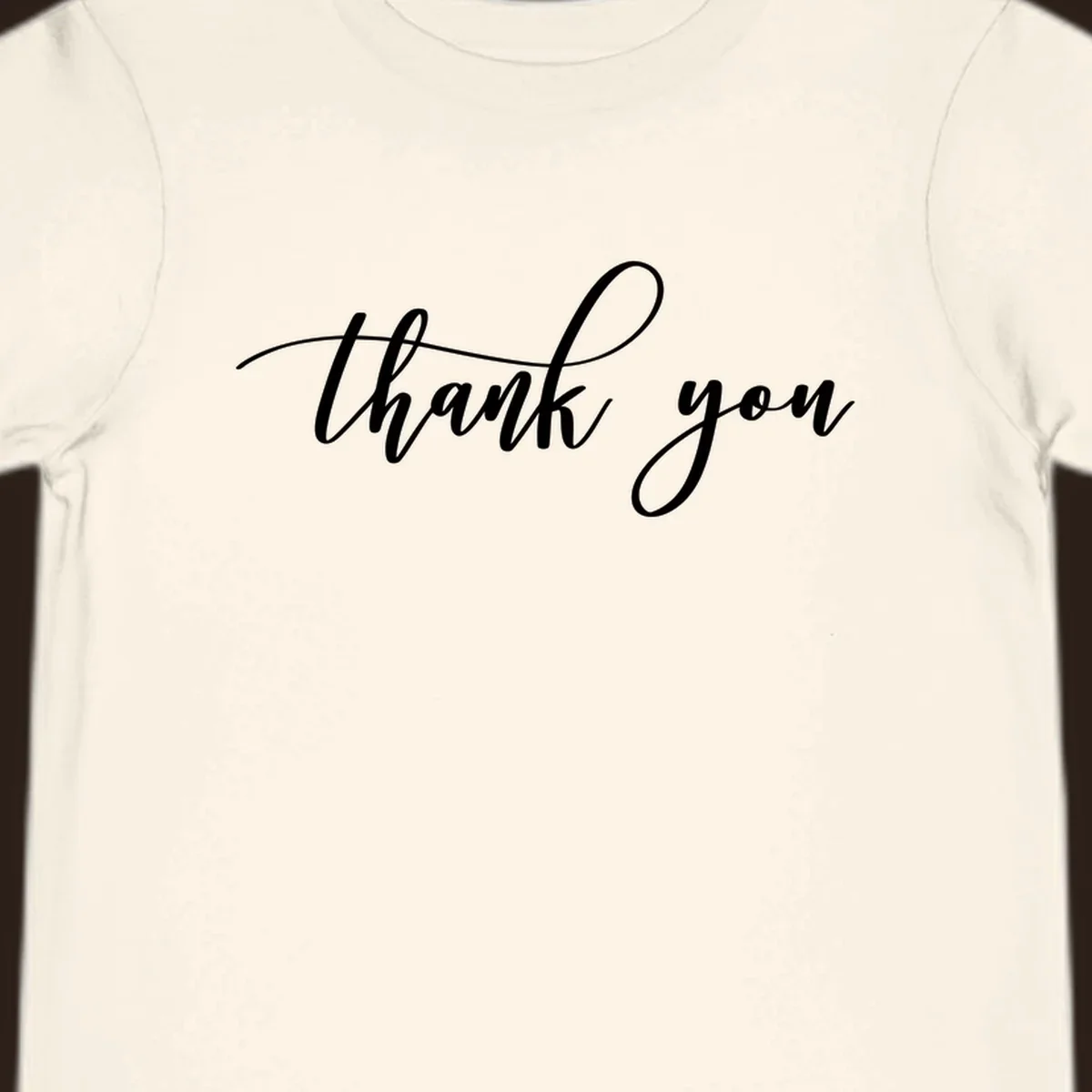 Elegant handwritten thank you script in white on a dark background.