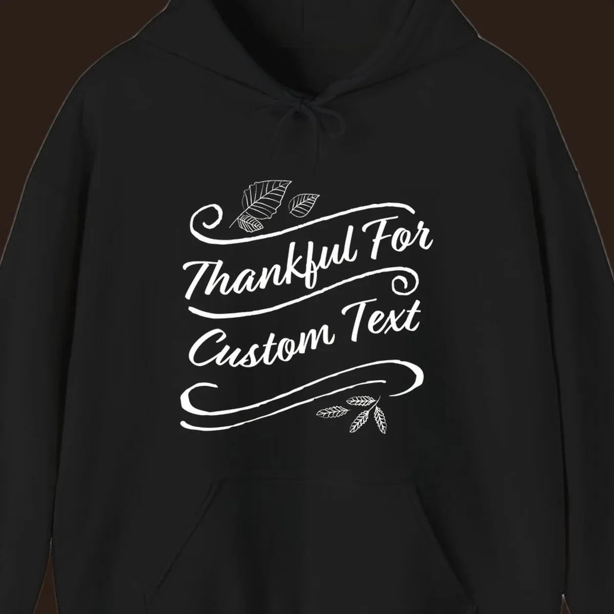 Custom Thanksgiving text design with leaves and swirls.