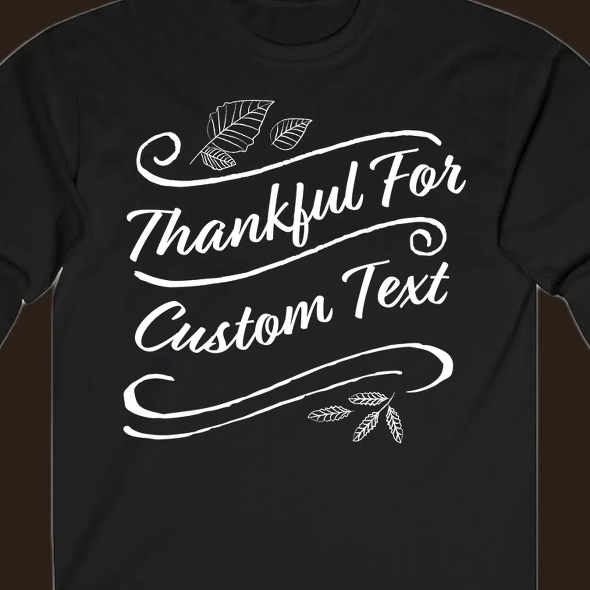 Custom Thanksgiving text design with leaves and swirls.