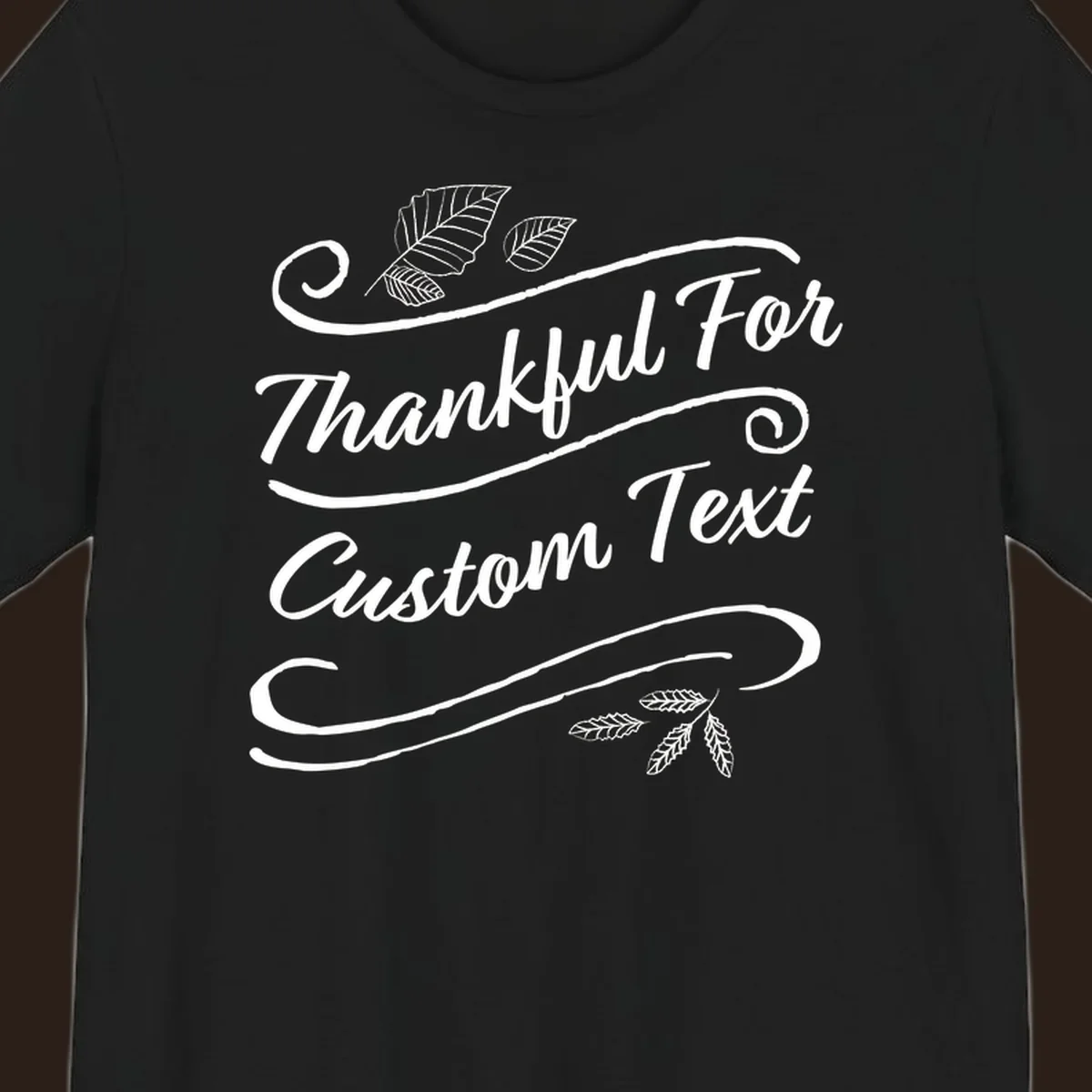 Custom Thanksgiving text design with leaves and swirls.