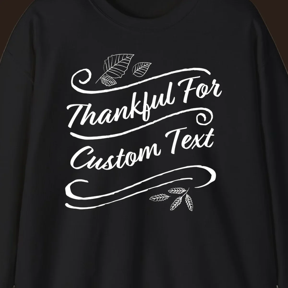Custom Thanksgiving text design with leaves and swirls.