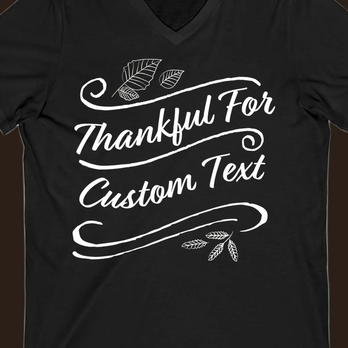 Custom Thanksgiving text design with leaves and swirls.