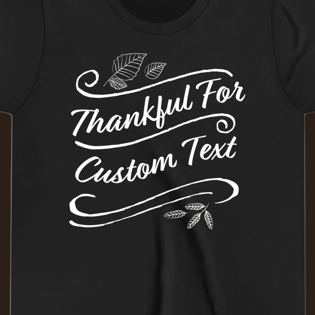 Custom Thanksgiving text design with leaves and swirls.
