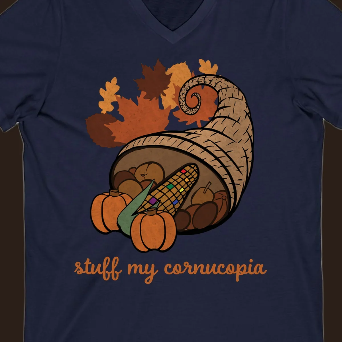 Cornucopia overflowing with harvest food and autumn leaves, with text 'stuff my cornucopia'.