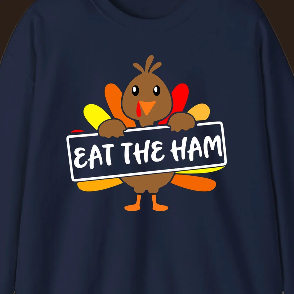 Cartoon turkey holding a sign that says EAT THE HAM, thanksgiving holiday.