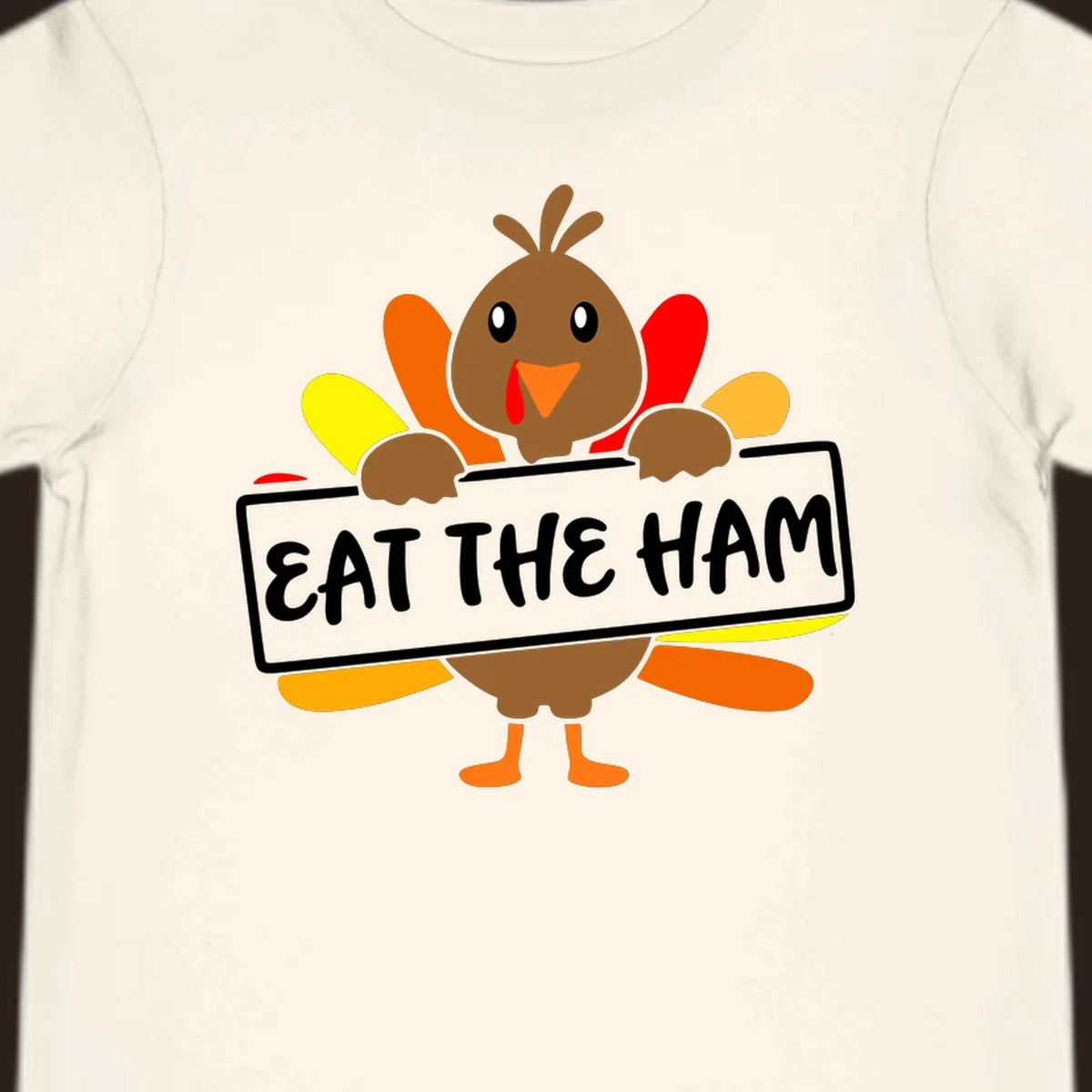 Cartoon turkey holding a sign that says EAT THE HAM, thanksgiving holiday.