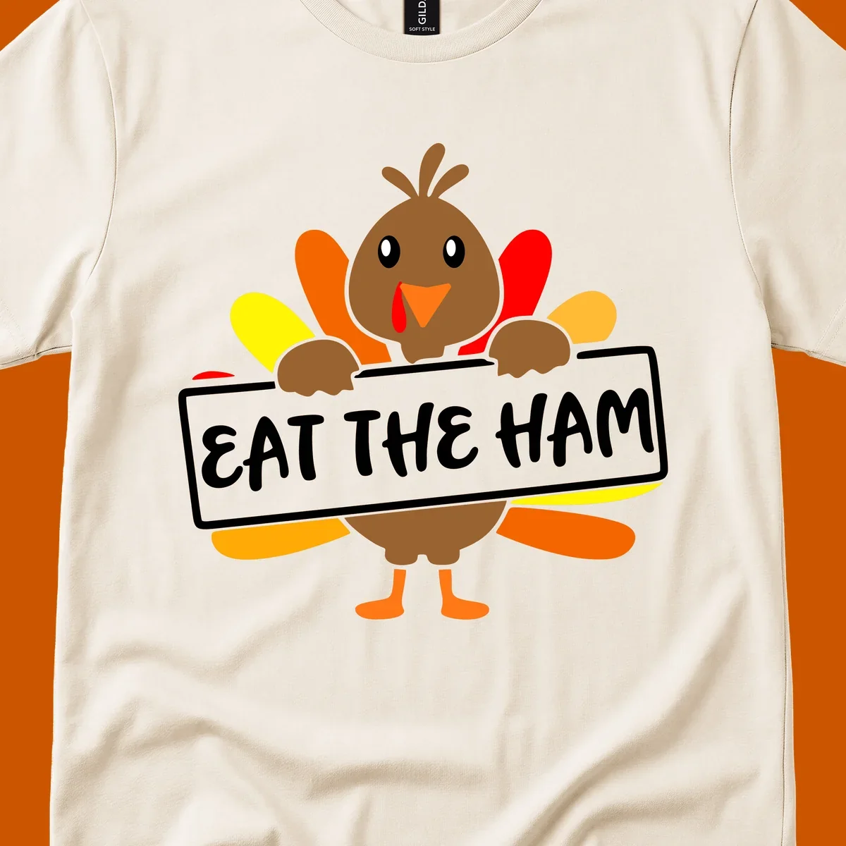 Cartoon turkey holding a sign that says EAT THE HAM, thanksgiving holiday.