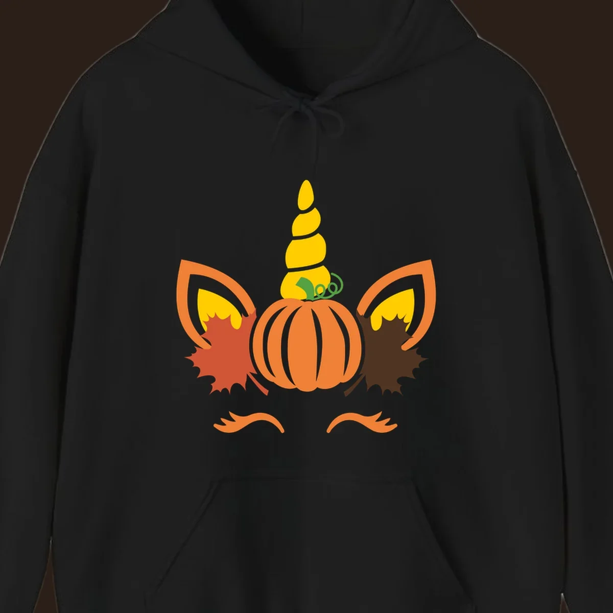 Autumn unicorn pumpkin face with fall leaves graphic.
