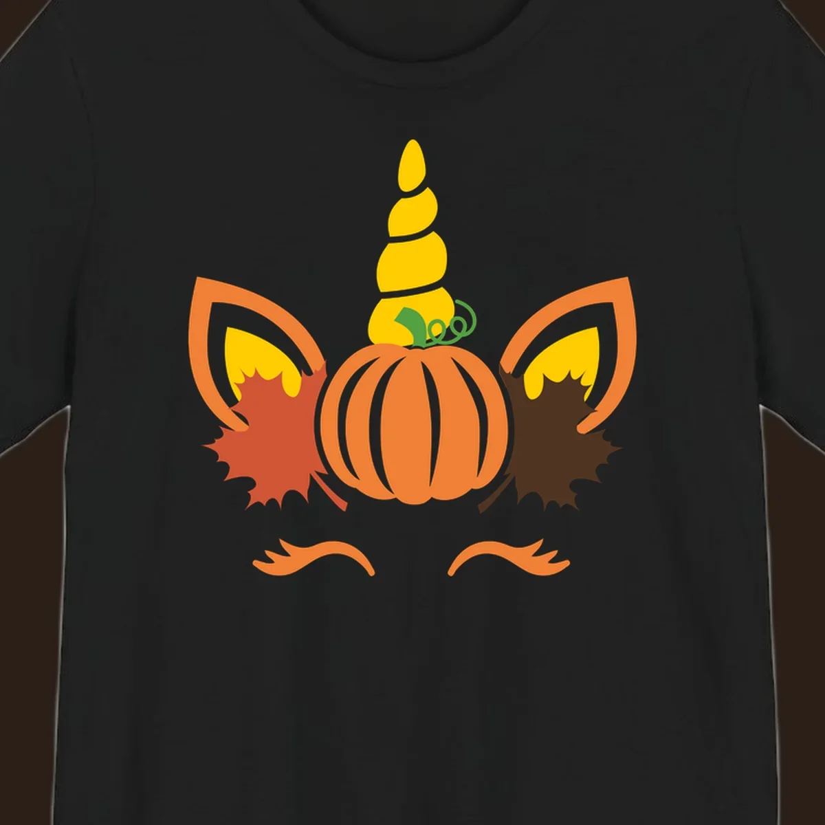 Autumn unicorn pumpkin face with fall leaves graphic.