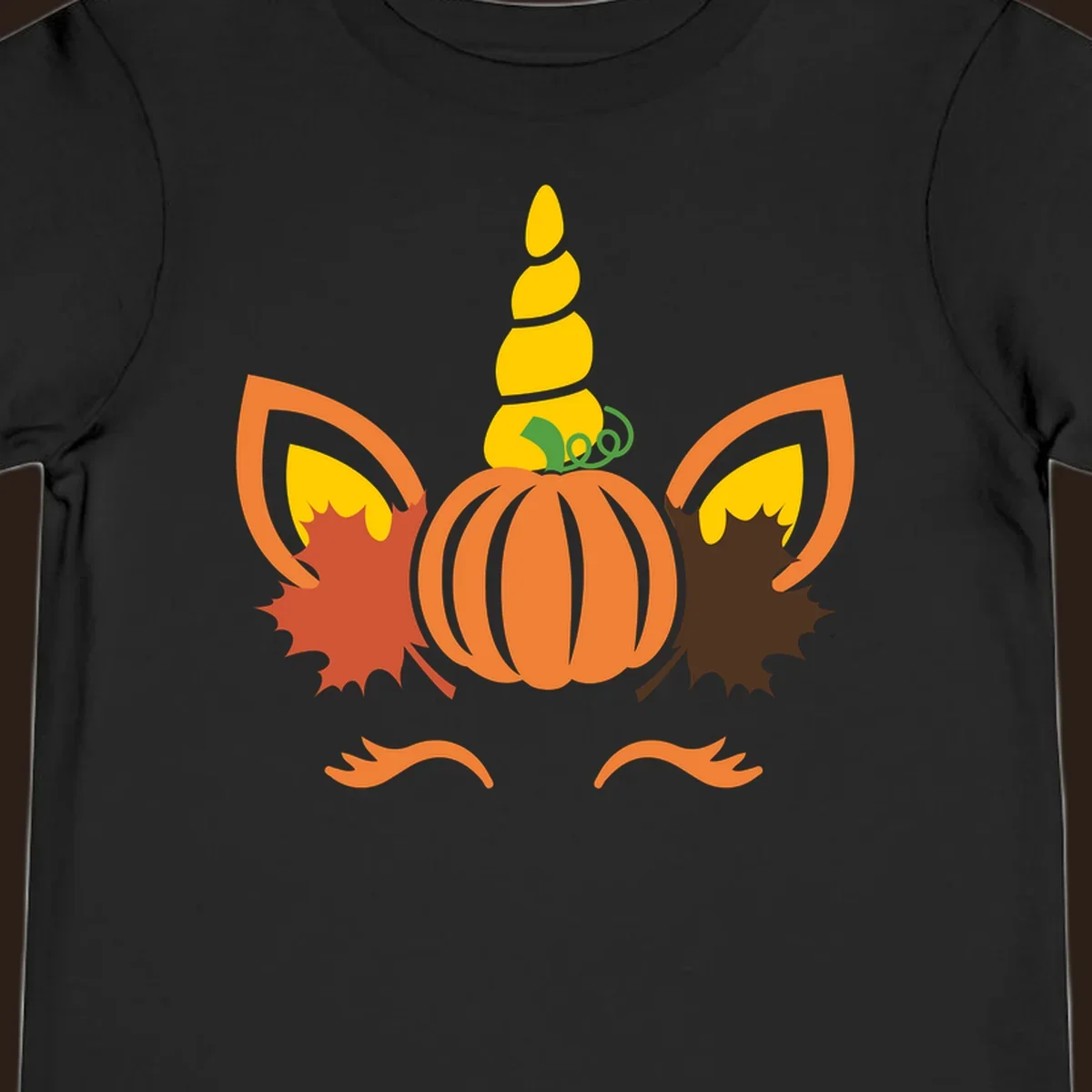 Autumn unicorn pumpkin face with fall leaves graphic.