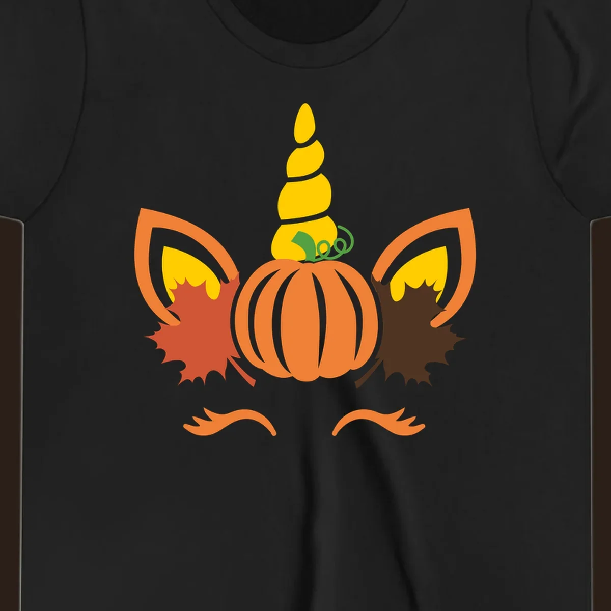 Autumn unicorn pumpkin face with fall leaves graphic.