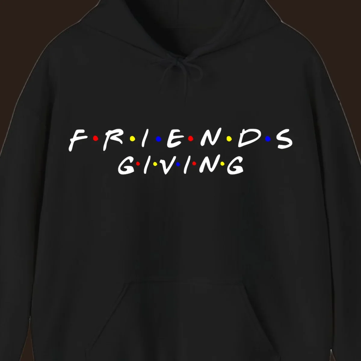 Friendsgiving typography design in white with red, yellow, and blue dots.