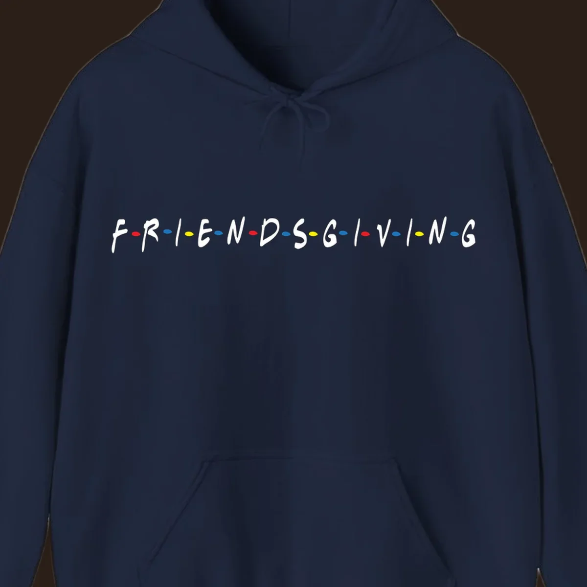 Friendsgiving typography design with white letters and colored dots on a black background.