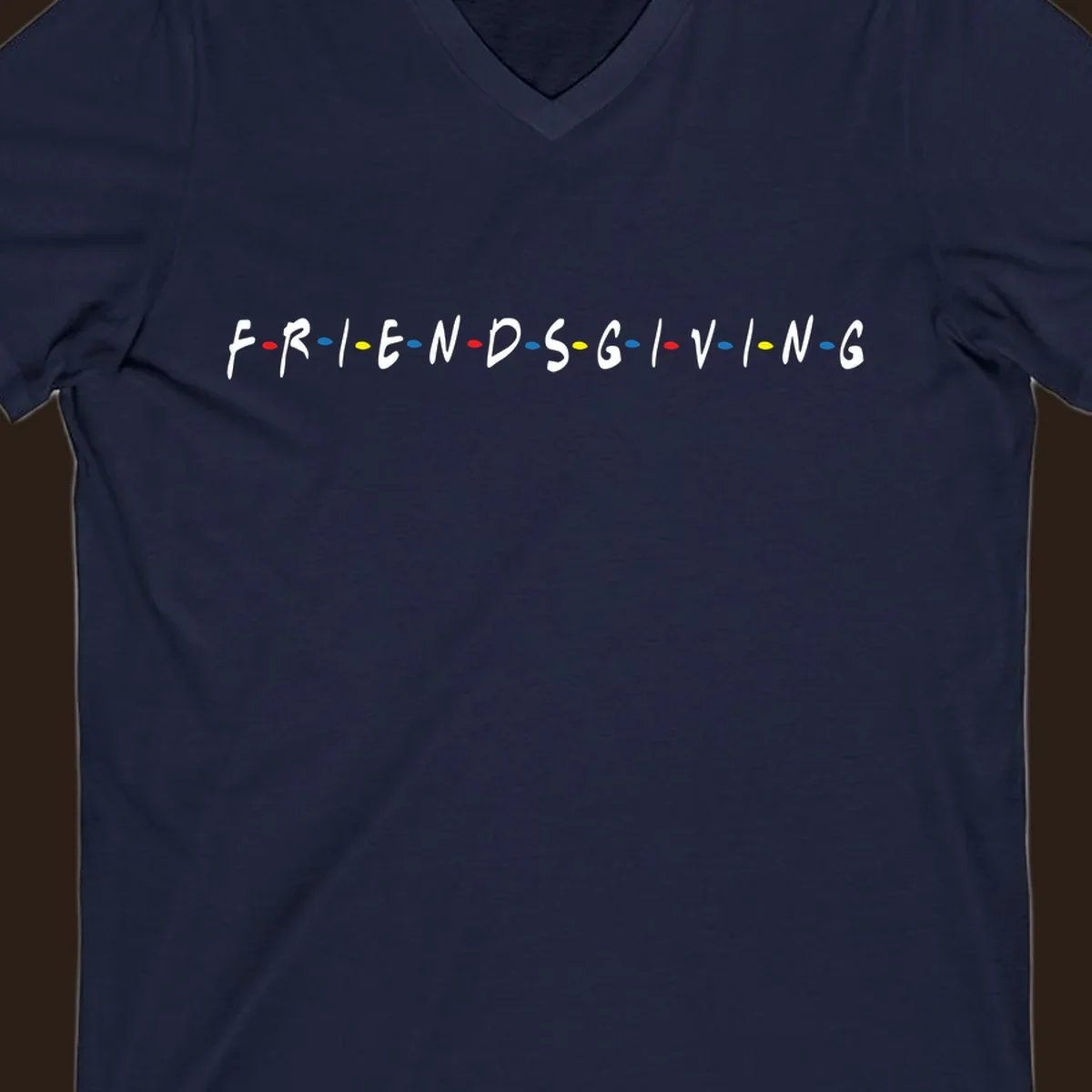 Friendsgiving typography design with white letters and colored dots on a black background.