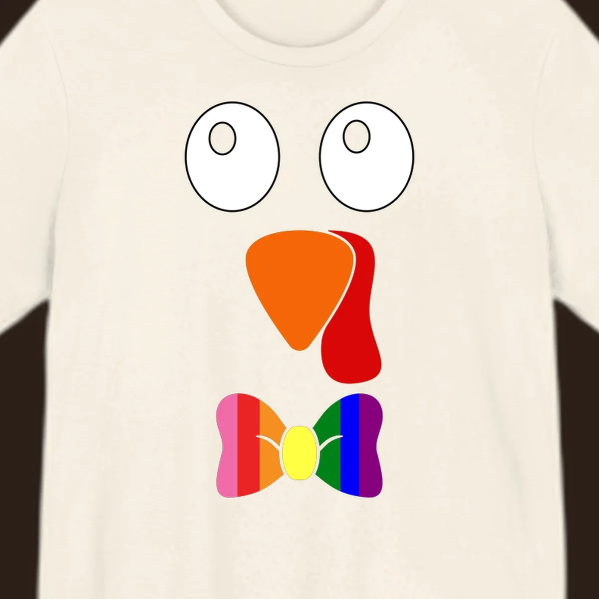 Cartoon turkey face with rainbow bowtie, featuring large eyes, orange beak, and red wattle. Thanksgiving holiday graphic.