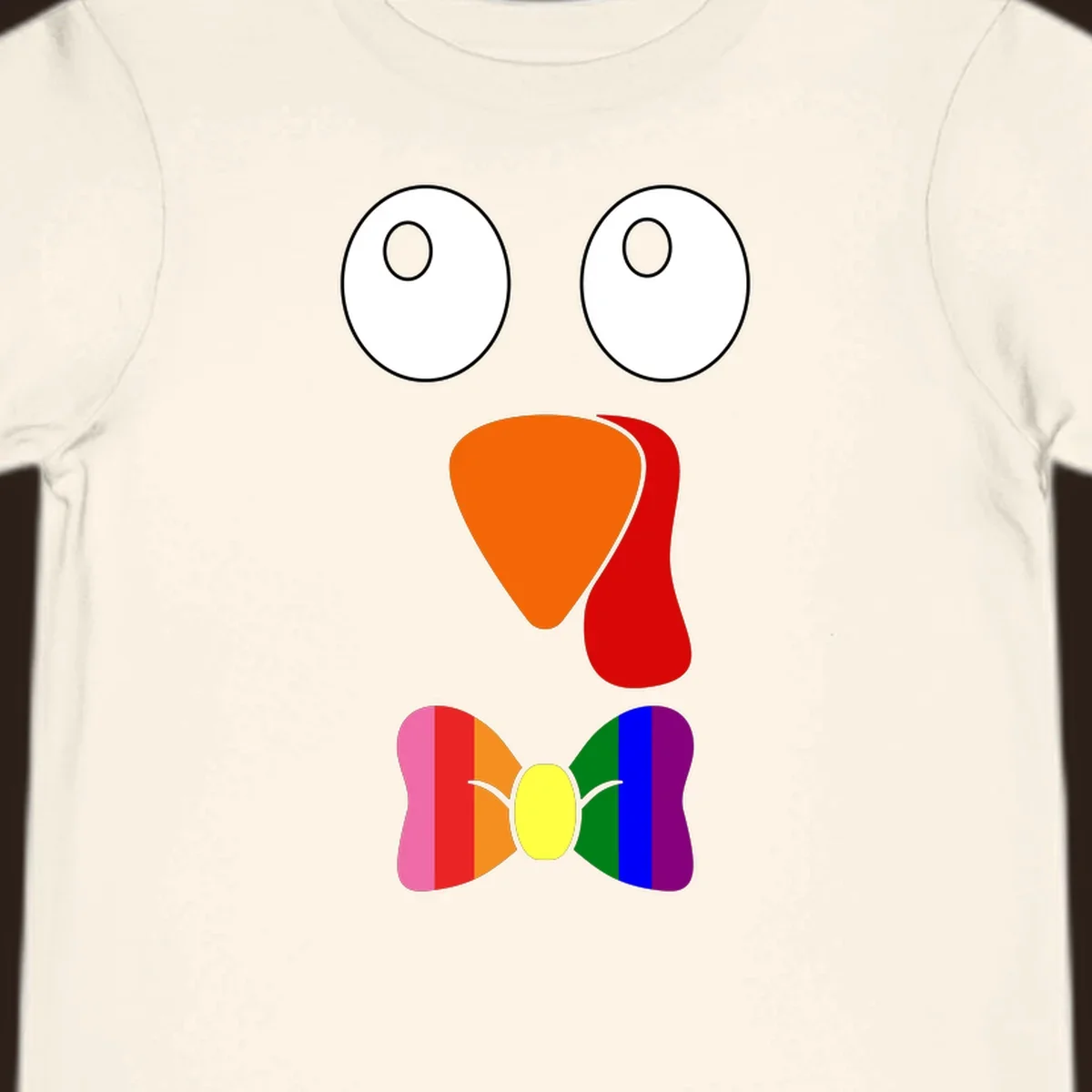 Cartoon turkey face with rainbow bowtie, featuring large eyes, orange beak, and red wattle. Thanksgiving holiday graphic.