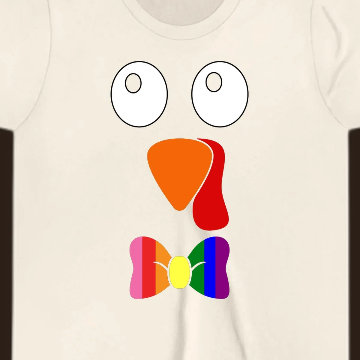 Cartoon turkey face with rainbow bowtie, featuring large eyes, orange beak, and red wattle. Thanksgiving holiday graphic.