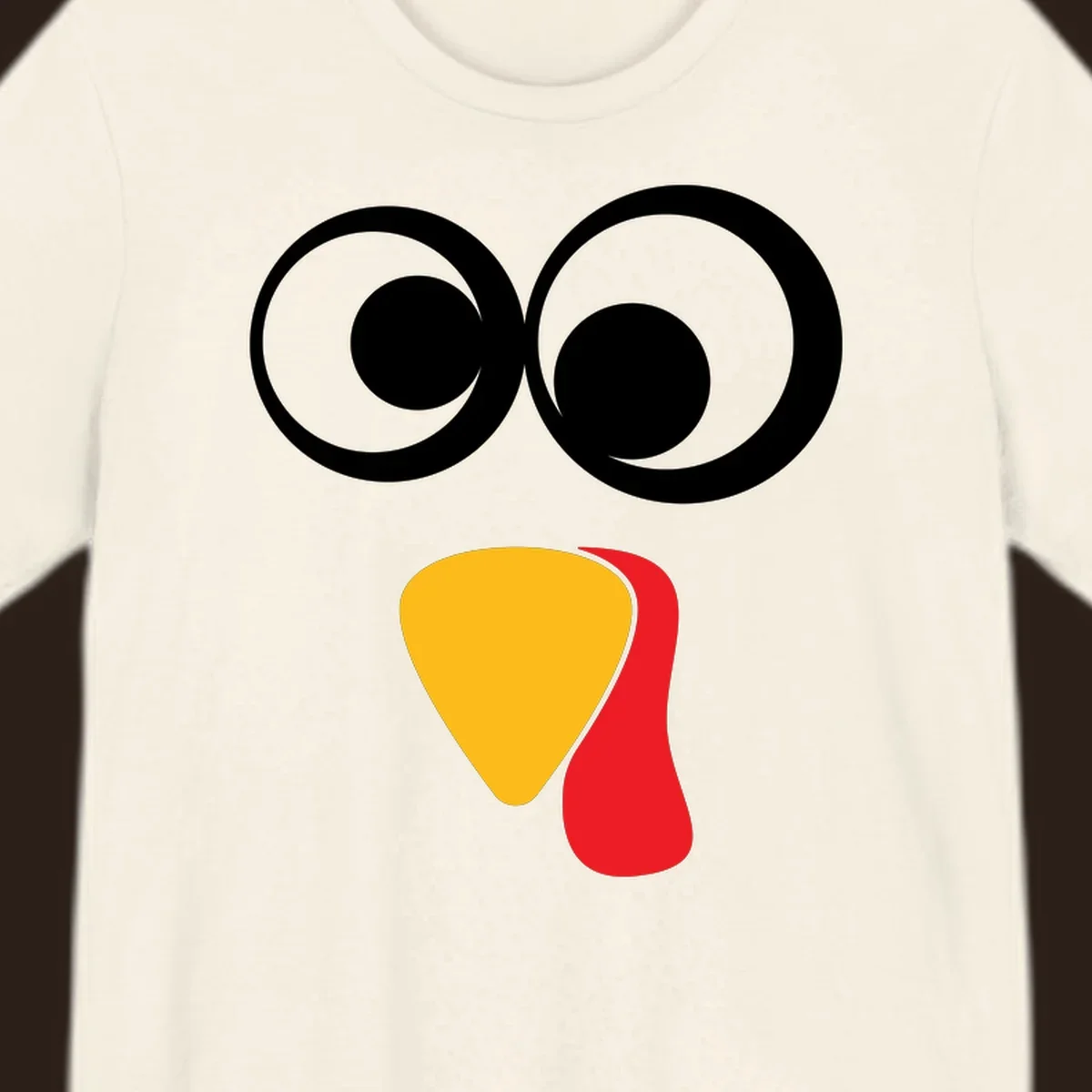 Googly-eyed turkey face illustration with yellow beak and red wattle.