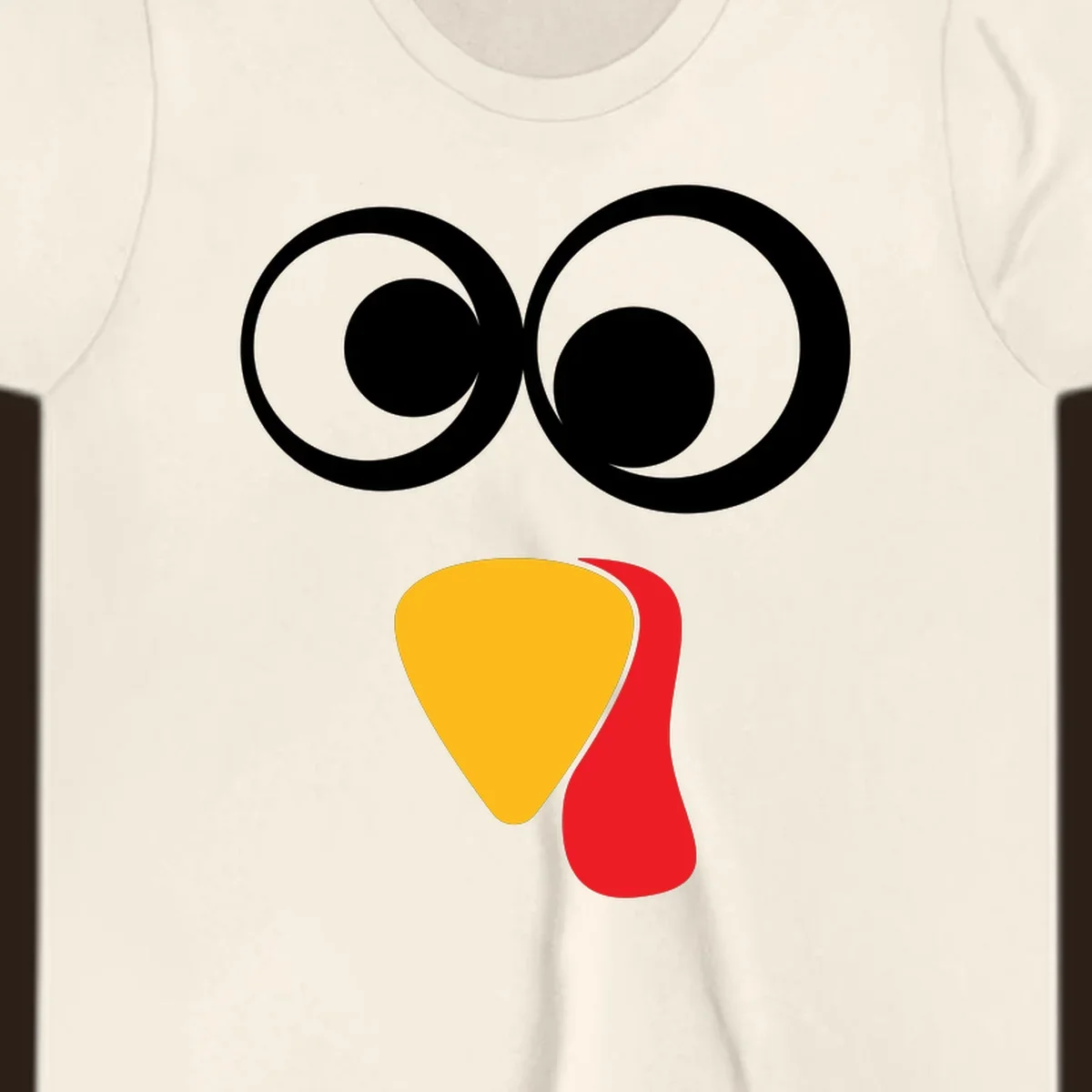 Googly-eyed turkey face illustration with yellow beak and red wattle.