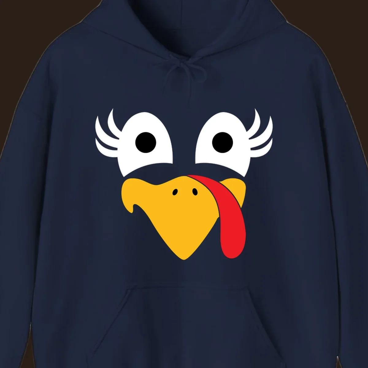 Funny turkey face illustration with googly eyes and a red wattle, for Thanksgiving.