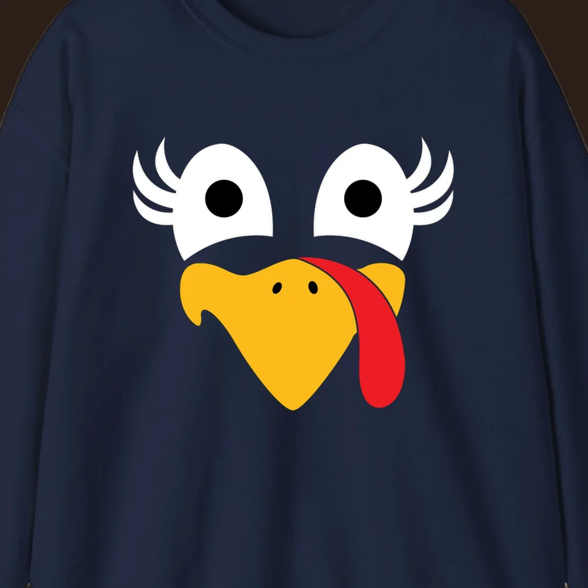 Funny turkey face illustration with googly eyes and a red wattle, for Thanksgiving.