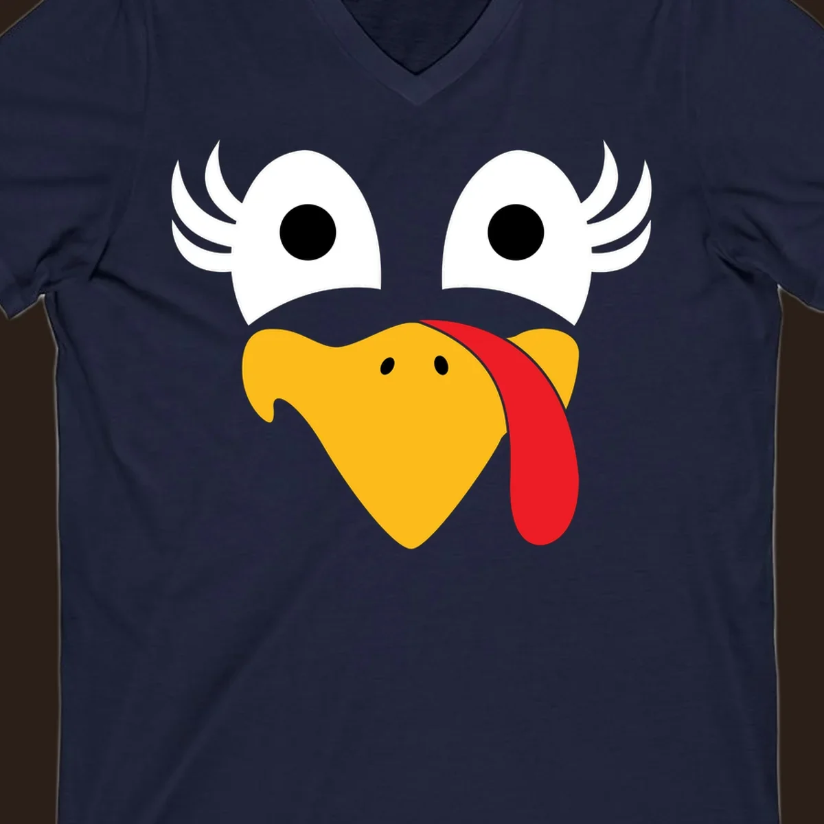 Funny turkey face illustration with googly eyes and a red wattle, for Thanksgiving.