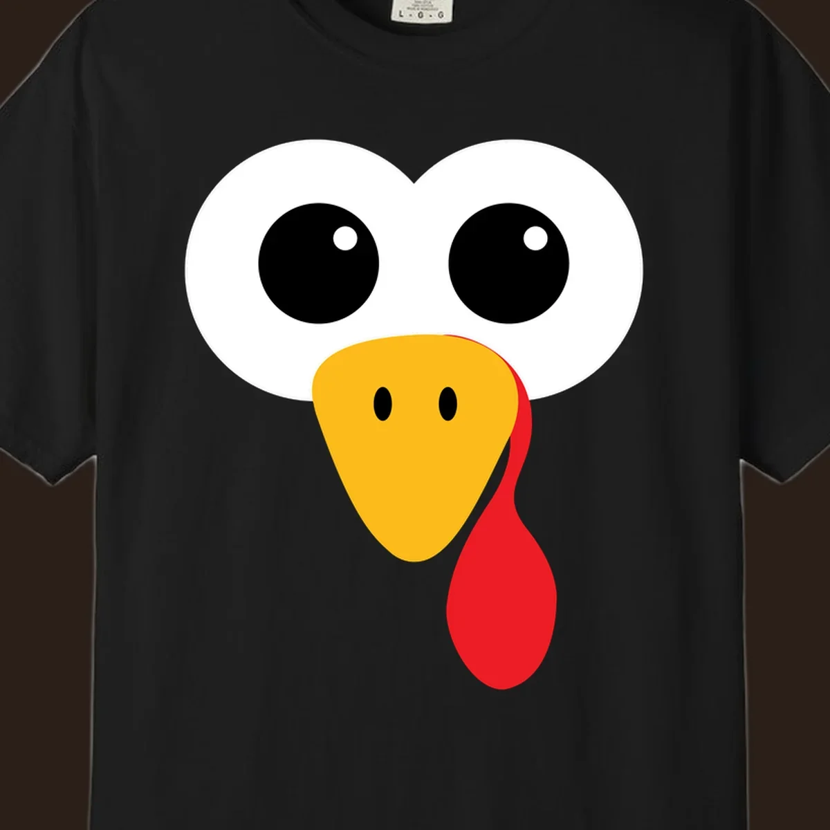 Funny turkey face with googly eyes, yellow beak, and red wattle for Thanksgiving.