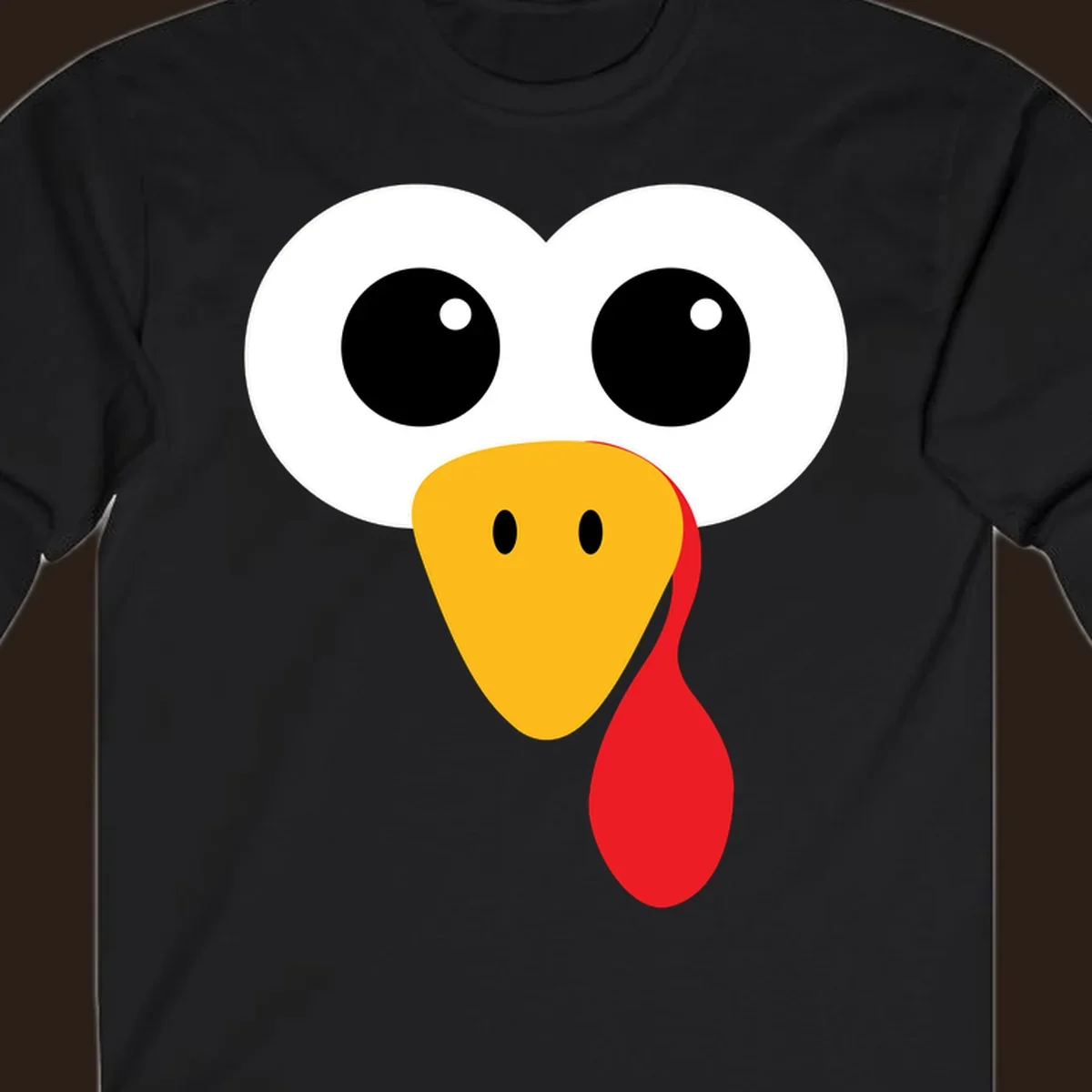 Funny turkey face with googly eyes, yellow beak, and red wattle for Thanksgiving.