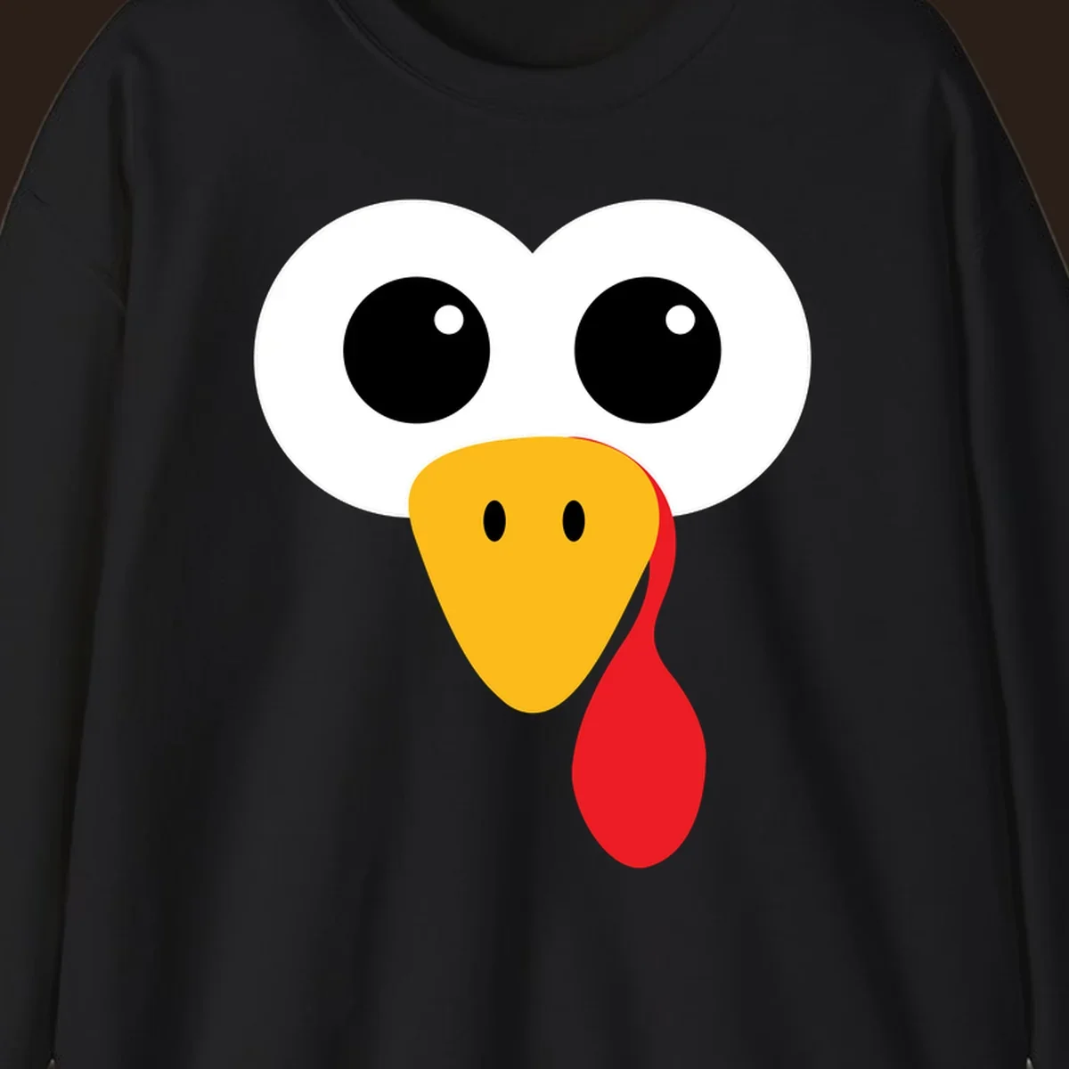 Funny turkey face with googly eyes, yellow beak, and red wattle for Thanksgiving.