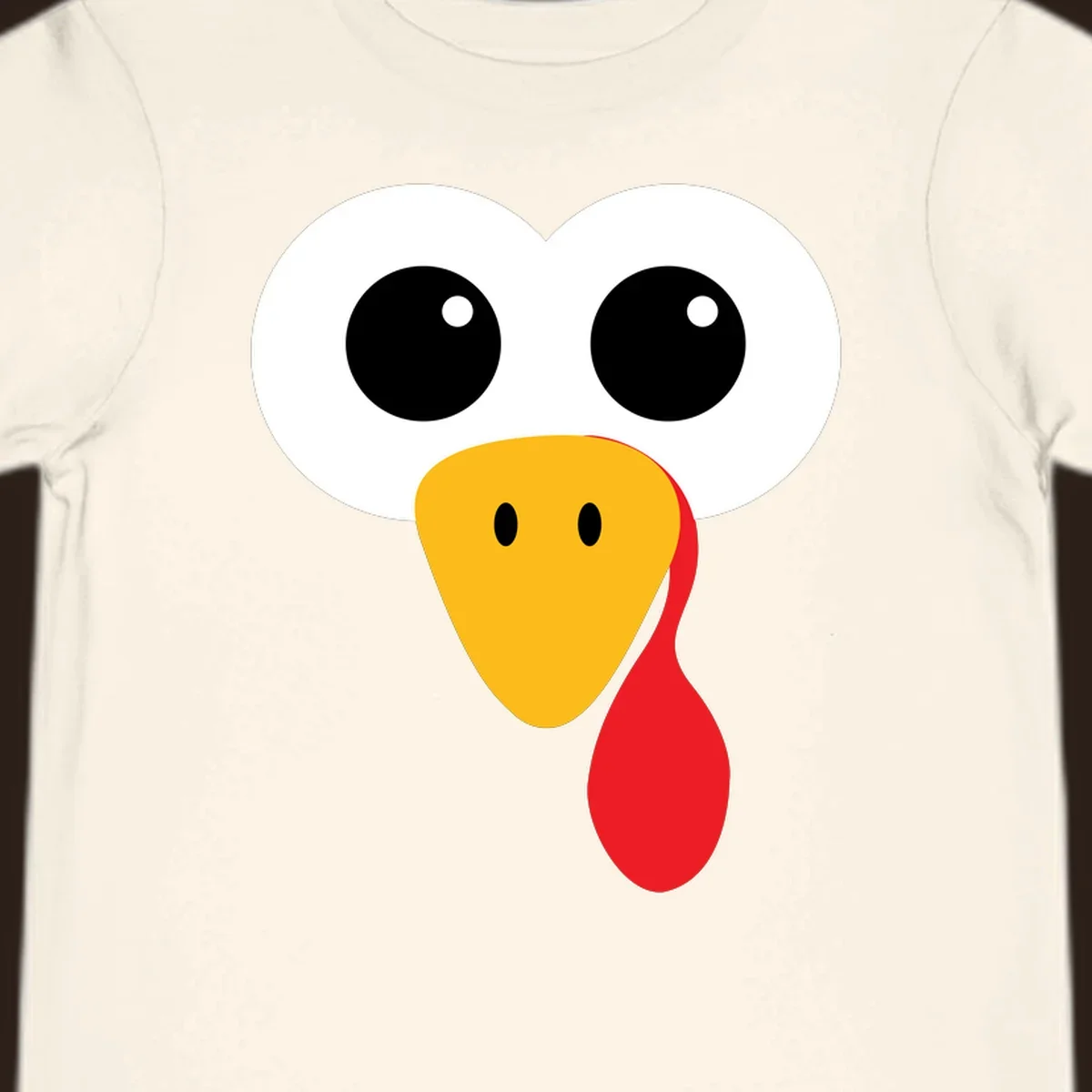 Funny turkey face with googly eyes, yellow beak, and red wattle for Thanksgiving.