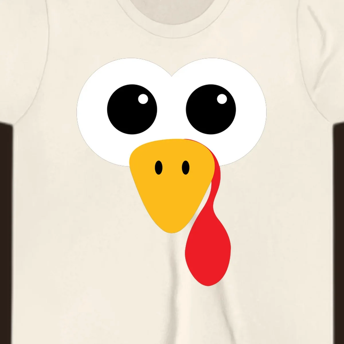 Funny turkey face with googly eyes, yellow beak, and red wattle for Thanksgiving.