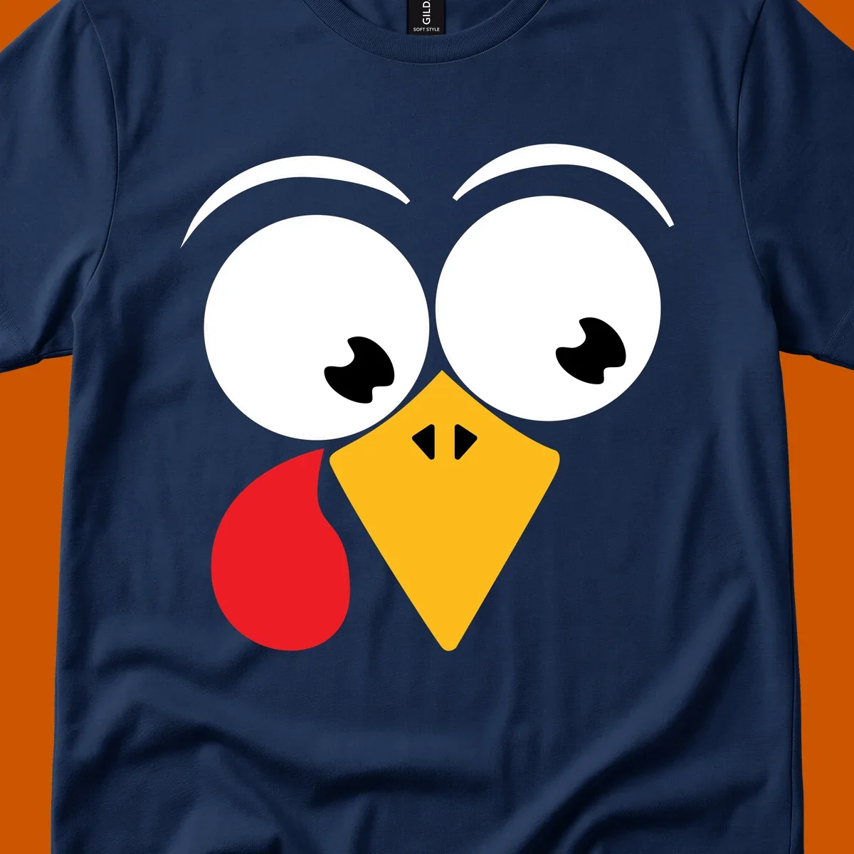 Googly eyed turkey face with yellow beak and red wattle on black background.