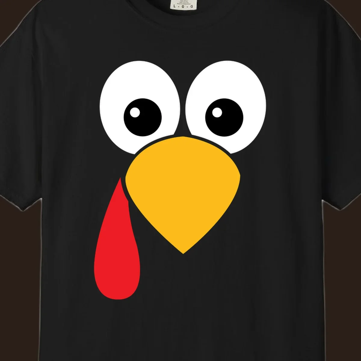 Funny turkey face illustration with big eyes, yellow beak, and red wattle for Thanksgiving.