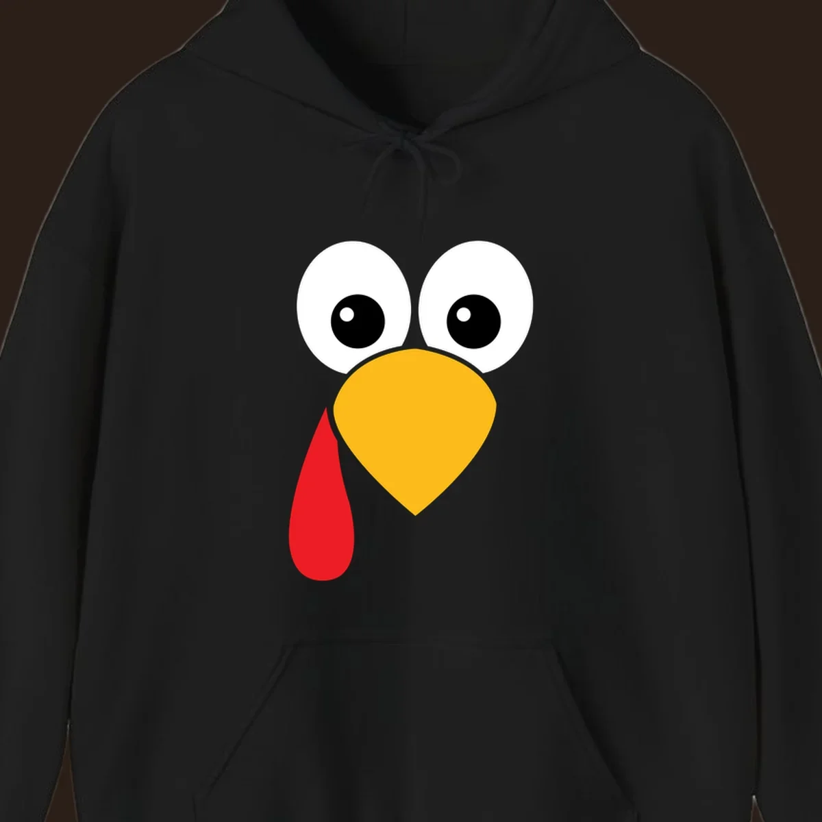 Funny turkey face illustration with big eyes, yellow beak, and red wattle for Thanksgiving.