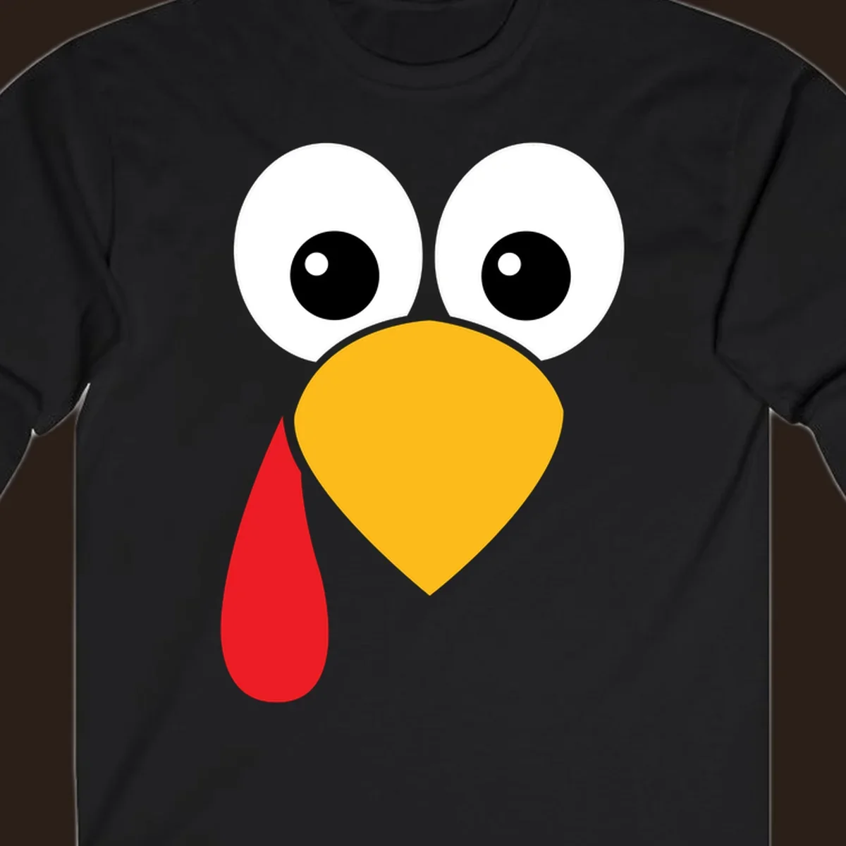 Funny turkey face illustration with big eyes, yellow beak, and red wattle for Thanksgiving.