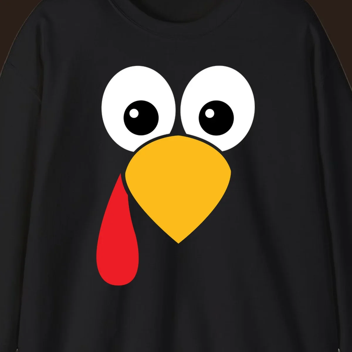 Funny turkey face illustration with big eyes, yellow beak, and red wattle for Thanksgiving.