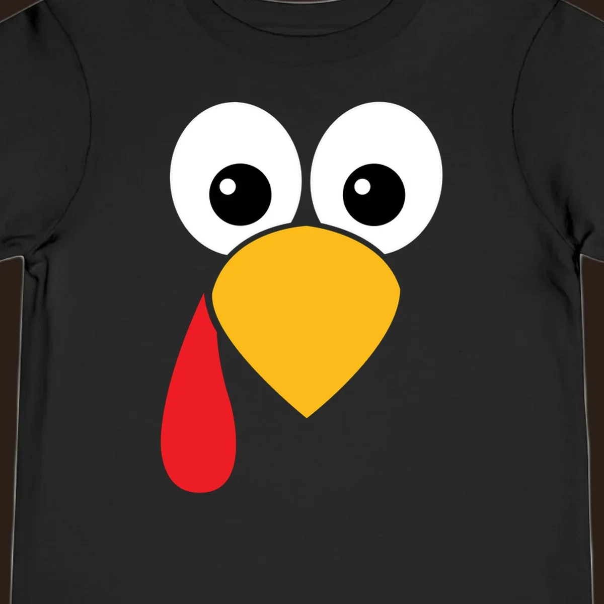 Funny turkey face illustration with big eyes, yellow beak, and red wattle for Thanksgiving.